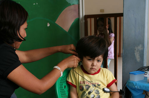 a boy getting his hearing tested